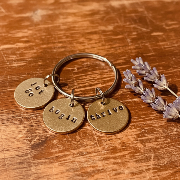 Let Go Begin Thrive charm — hand-stamped bronze keepsake