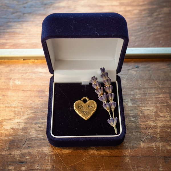 Itty bitty bronze heart charm — sweet love gift handmade in Arizona